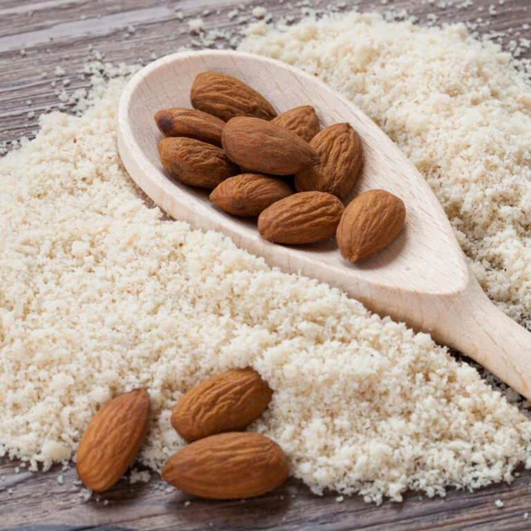 Raw almonds and finely ground almond flour, used for organic almond oil production